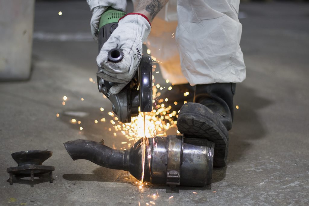 Worker is cutting autocatalyst